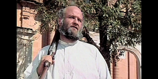 Victor Buono as Jennings, gun in hand, wondering about Father Van Horne's plan in The Wrath of God (1972)