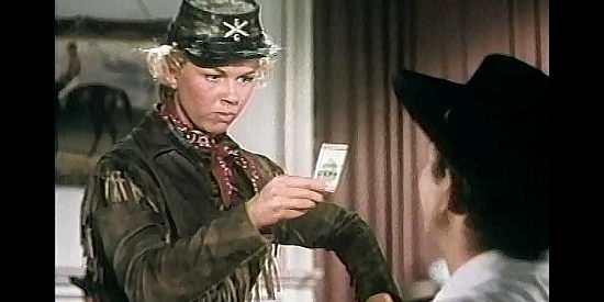 Doris Day as Calamity Janes, studying the cigarette card of Adelaid Adams all the men have been fussing over in Calamity Jane (1953)