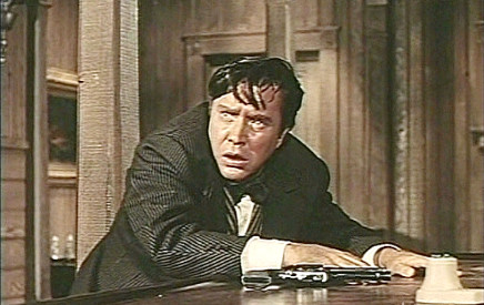 Edmund O'Brien as Joe Jagger, facing a possible showdown with Brog in The Big Land (1957)
