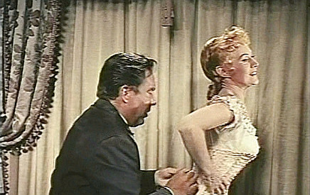 Edmund O'Brien as Joe Jagger helping sister Helen (Virginia Mayo) get dressed in The Big Land (1957)