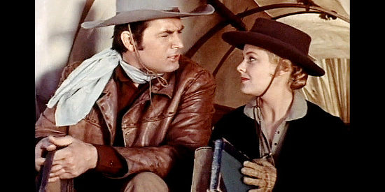 Fess Parker as John 'Doc' Grayson and Kathleen Crowley as Laura Thompson, finding the books he's been studying in Westward Ho the Wagons! (1956)