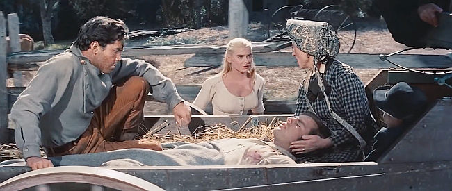 Hope Lange as Zee frightened as Frank (Jeffrey Hunter) and Mrs. Samuel (Agnes Moorehead) bring home a wounded Jesse in The True Story of Jesse James (1957)
