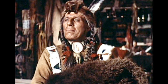 Iron Eyes Cody as Many Stars, the medicine man convinced of Myra Thompson's power in Westward Ho the Wagons! (1956)