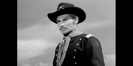 Jeff Chandler as Maj. Kenniston, preparing to kill the son of an Indian chief in Two Flags West (1950)