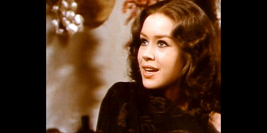 Maribel Martin as Rosy, baffled at the way her clothes starting falling off in the middle of a gun battle; in truth, a ghost was at work in Whiskey and Ghosts (1974)