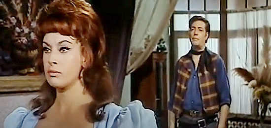 Marta Padovan (Martha Dovan) as Lois Duval, hearing from Holloway (Cesar Ojinaga) that Clark Harrison has returned in Ruthless Colt of the Gringo (1966)