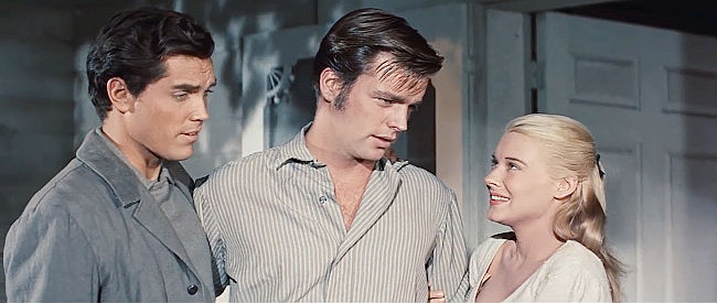 Robert Wagner as Jesse James announces his plan to marry Zee (Hope Lange) as brother Frank (Jeffrey Hunter) looks on in The True Story of Jesse James (1957)