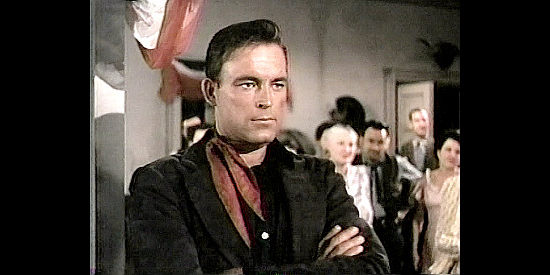 Scott Brady as Glenn Denbow, watching his girlfriend dance with another man in Untamed Frontier (1952)