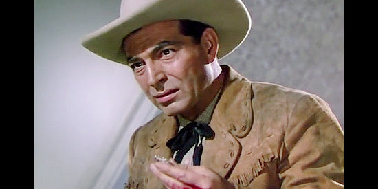 Stephen McNally as Marshal Lightning Tyrone, finding an incriminating piece of evidence in The Duel at Silver Creek (1952)