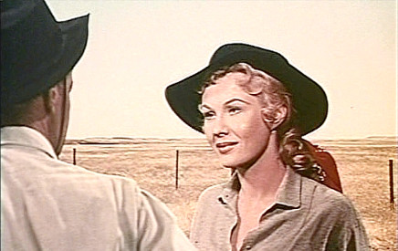 Virginia Mayo as Helen Jagger with Chad Morgan as he prepares to ride back to Texas in The Big Land (1957)