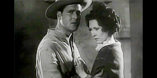 Bruce Warren as Lt. Al Dickinson tells wife Ann (Ruth Findlay) of the bleak prospects in Heroes of the Alamo (1937)