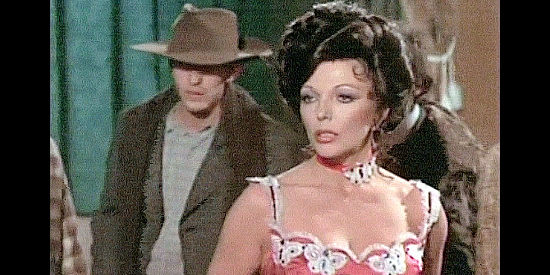 Joan Collins as Sonia Kendall, her performance interrupted by Bates' men in The Great Adventure (1975)