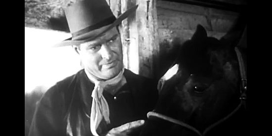 Leif Erickson as Bob Marshall, providing Bill tips on how to care for Blue Chip in Born to the Saddle (1953)