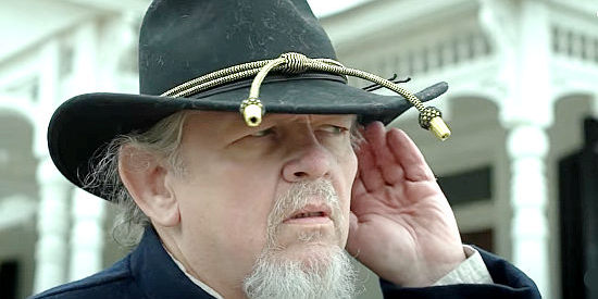 Joseph Zuchowski as Peabody, Sherman's quartermaster, with his ear on suspicious singing in American Confederate (2019)