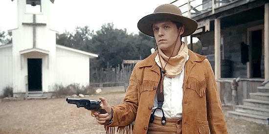 Bailey Roberts as Parker, helping even the odds in a gunfight in The Bounty Men (2022)