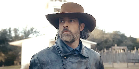 Dylan Hobbs as Daniel King, arriving in the town where he'll begin his search for John Doolings in The Bounty Men (2022)
