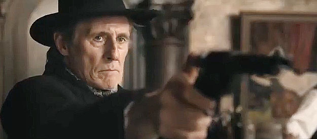 Gabriel Byrne as Sheriff Jim Ambrose, ready to defend his town in Murder at Yellowstone City (2022)