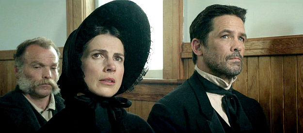 Genevieve Steele as M'Rye Beech with husband Abner (Billy Campbell), listening to an impassioned plea in church in Copperhead (2013)