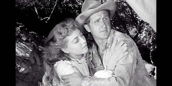 Marie Windsor as Laura Thompson and Lloyd Bridges as Ben Trask have their romantic interlude interrupted in The Tall Texan (1953)