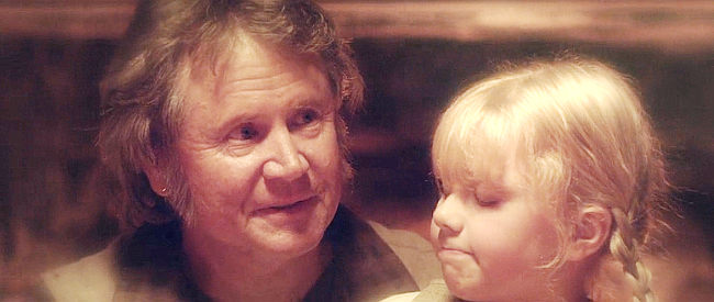 Robert Pierce as Papa Leininger with young Regina in a flashback scene from Alone Yet Not Alone (2013)