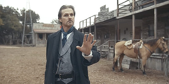 Tom Zembrod as John Dooling, wary of changing odds in The Bounty Men (2022)