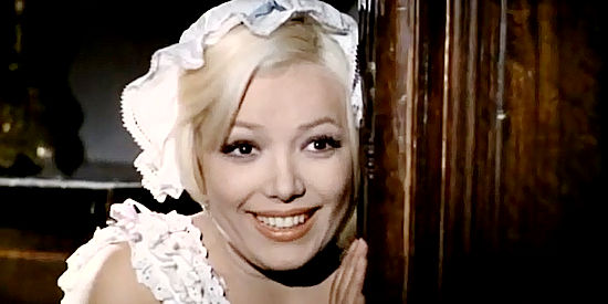 Agata Lys as Yolanda, humored as she watches the supermen get the better of Navajo Joe in Three Supermen of the West (1973)
