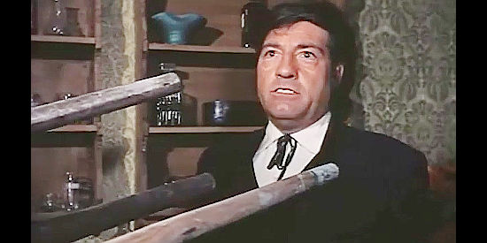 Cesar Ojinaga as Black Jack, threatened with walking sticks after swindling the Wesley brothers in Fabulous Trinity (1972)