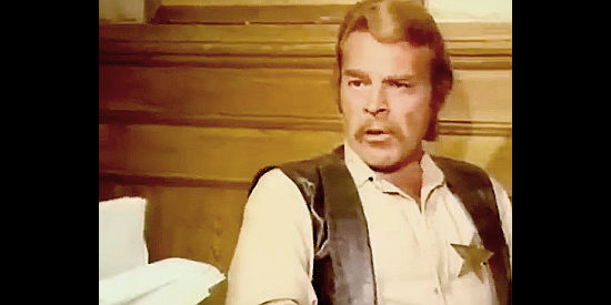 Ernesto Vanes (Dan Forest) as a sheriff who deliberately sends the bounty men in the wrong direction in If You Shoot ... You Live! (1975)
