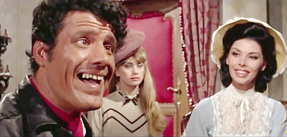 Franco Franchi as Django, shocked at the reading of Ringo's will while Dorothy (Gloria Paul) and Marisol (Orchidea de Santos) look on in Two Sons of Ringo (1966)