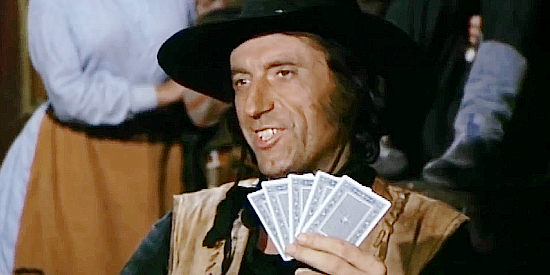 Herbert Fux as the bandit leader, with what he's sure will be a winning hand in Trinity Plus the Clown and a Guitar (1975)