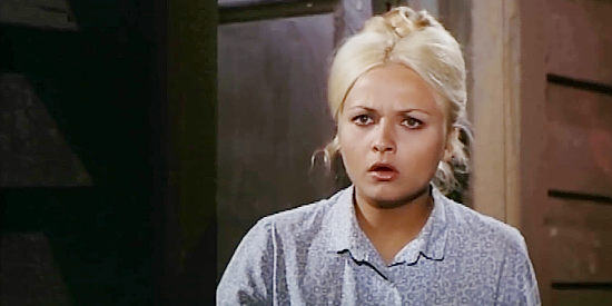Katty Santos as Blondie, watching El Moro's men ride into Little Lake in Trinity Plus the Clown and a Guitar (1975)