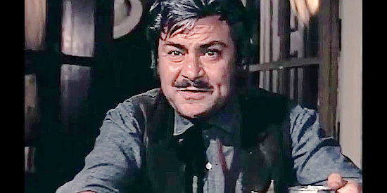 Luis Nonell as Sheriff John of the town of Watson, talking bounties with Scott in Fabulous Trinity (1972)