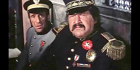 Luis Omar as Capt. Juarez and Fernando Sancho as Col. Jimenez, listening to Scott's offer of help in Fabulous Trinity (1972)