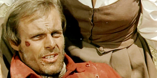 Mike Marshall as Bobby Kent, the Pony Express rider explaining his plight to the pioneers after they find him beaten in Death Rides Along (1967)