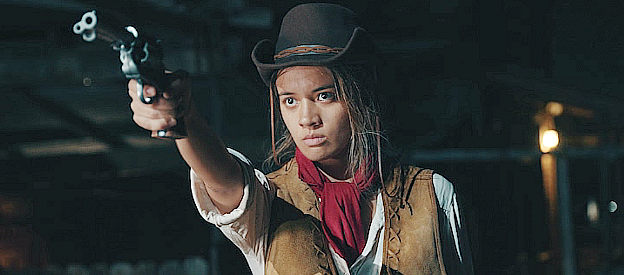 Olivia Hsu as Billie, fixing her six-gun on a vampire in Billie the Kid (2022)