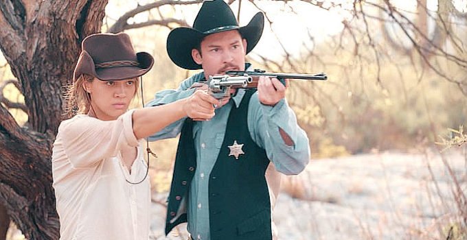 Olivia Hsu as Billie and Frank Prell as Sheriff Jack Barton, taking aim at a vampire in Billie the Kid (2022)