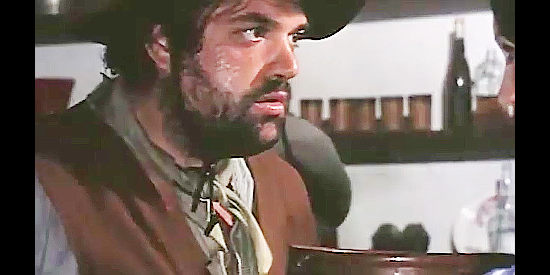 Ricardo Palacios as Ray Wesley, being slipped a six-gun by the disguised Nora in Fabulous Trinity (1972)