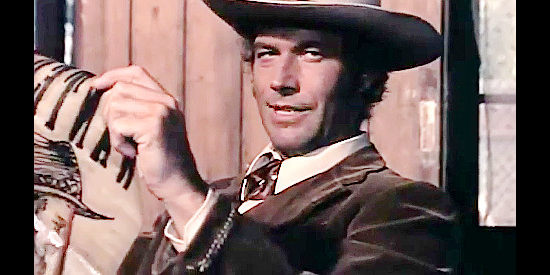 Richard Harrison as Scott, learning of a new bounty up for grabs in Fabuous Trinity (1972)