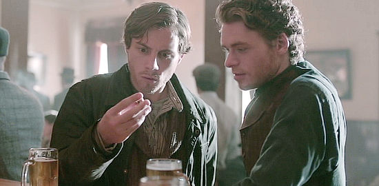 Augustus Pew as Byron Epstein and Richard Madden as Bill Haskell, studying a nugget that prompted their journey to the Yukon in Klondike (2014)
