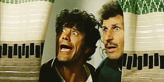 Franco Franchi as Franco La Vacca and Ciccio Ingrassia as Ciicio La Vacce, spotting Zorro in the home where they're staying in The Two Nephews of Zorro (1969)