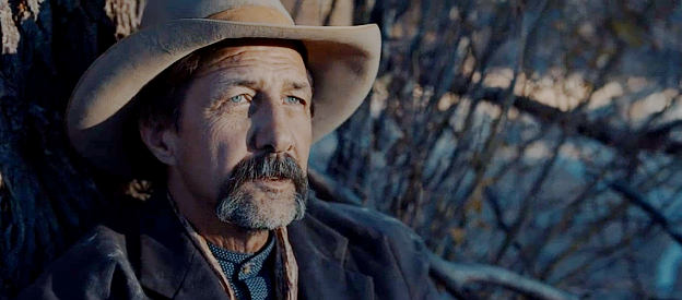 John Marrs as Jack Travers, the man who has spent years searching for the wife who left him in Heart of the Gun (2021)