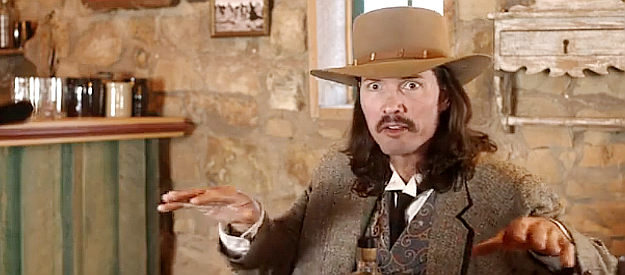 Ryan Knudson as Doc Holliday, humored by all this delving into the past in 30 Seconds in Hell (2021)