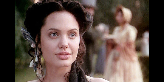 Angelina Jolie as Georgia Lawshe Woods, a Georgia born beauty who finds herself on the Texas frontier in True Women (1997)