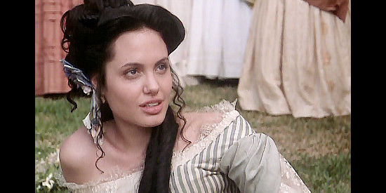 Angelina Jolie as Georgia Virginia Lawshe, falling for a young doctor in True Women (1997)
