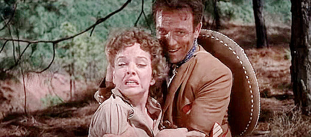 Dane Clark as Capt. Ramon, forcing Angelica Chavez (Martha Roth) to watch the Yaqui torture two men in Massacre (1956)