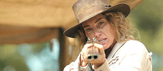 Faith Hill as Margaret Dutton, springing into action as bandits invade the wagon train's camp in 1883 (2021-22)
