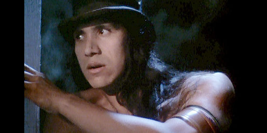 Michael Greyeyes as the feared Comanche chief Tarantula, scouting the McClure homestead in True Women (1997)