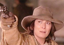 Anjelica Huston as Calamity Jane, shooting down the corpse of Jack McCall in Buffalo Girls (1995)
