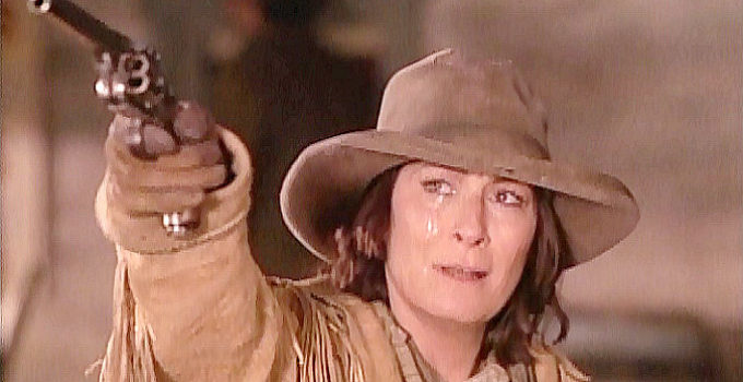 Anjelica Huston as Calamity Jane, shooting down the corpse of Jack McCall in Buffalo Girls (1995)