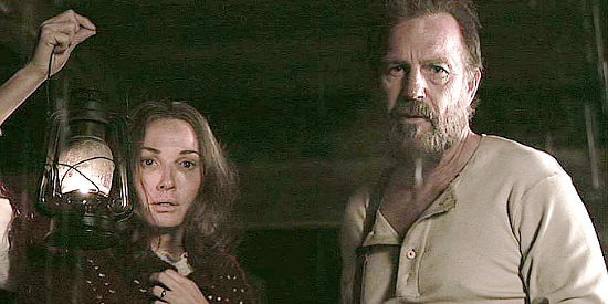 Sarah Parish as Levicy Hatfield and Kevin Costner as Anse Hatfield, learning son Johnse is in danger in Hatfields & McCoys (2012)